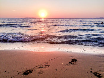 Scenic view of beach against sky during sunset