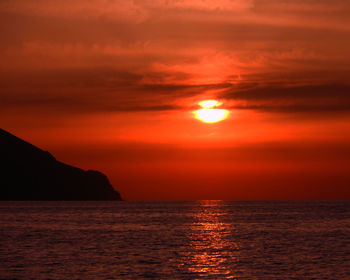 Scenic view of sea against romantic sky at sunset