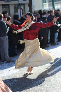 Full length of woman dancing on city street