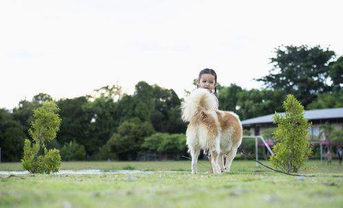 Side view of dog running on field