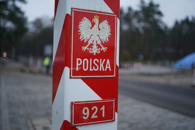 Close-up of sign on sidewalk