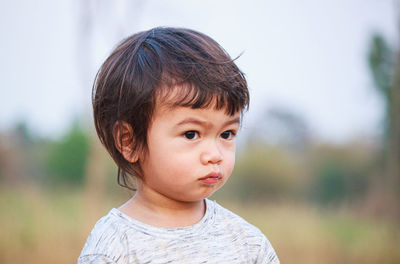 Close-up of cute girl looking away