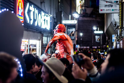 People on street in city at night