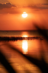 Scenic view of sea against romantic sky at sunset