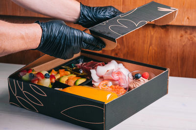 Midsection of man preparing food on table