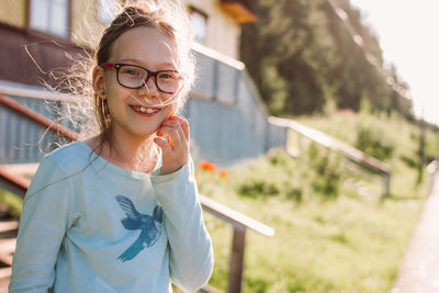 Girl wearing eyeglasses while standing outdoors