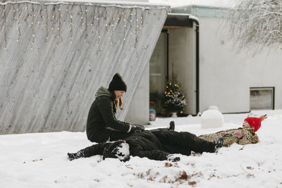 Mother with children doing snow angels