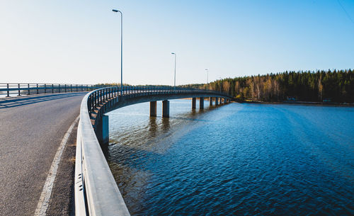 Pier over river against clear sky