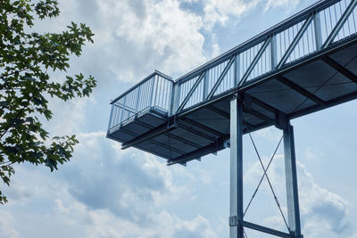 View from below on a skywalk made of gratings, where tourists can look over a valley