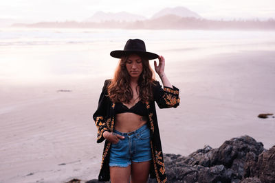 Beautiful, stylish woman on cox bay beach in tofino