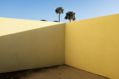 Yellow wall against blue sky