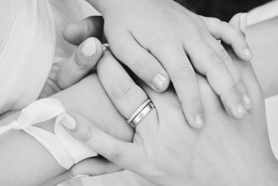 Midsection of couple holding hands