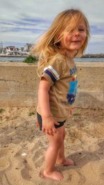Full length portrait of girl standing on beach
