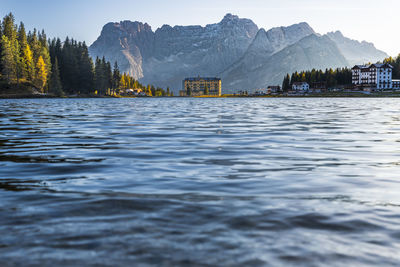 Scenic view of lake by buildings against sky