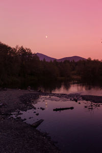 Scenic view of calm lake at sunset