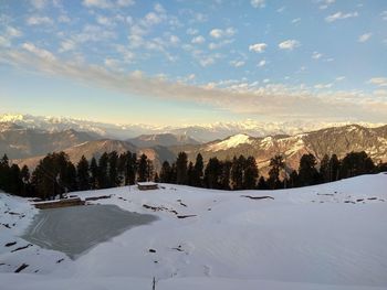 Scenic view of snow covered landscape against sky