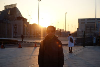 Portrait of man in city against sky