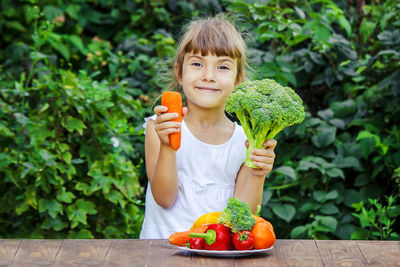 Young woman holding plant