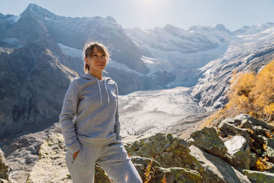 Portrait of young man standing on mountain