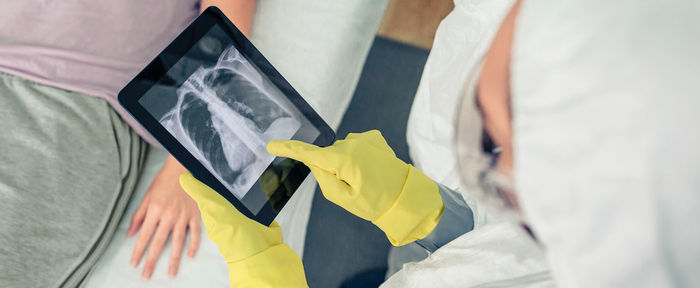 Midsection of woman using digital tablet