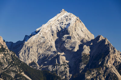 Scenic view of snowcapped mountains against clear blue sky