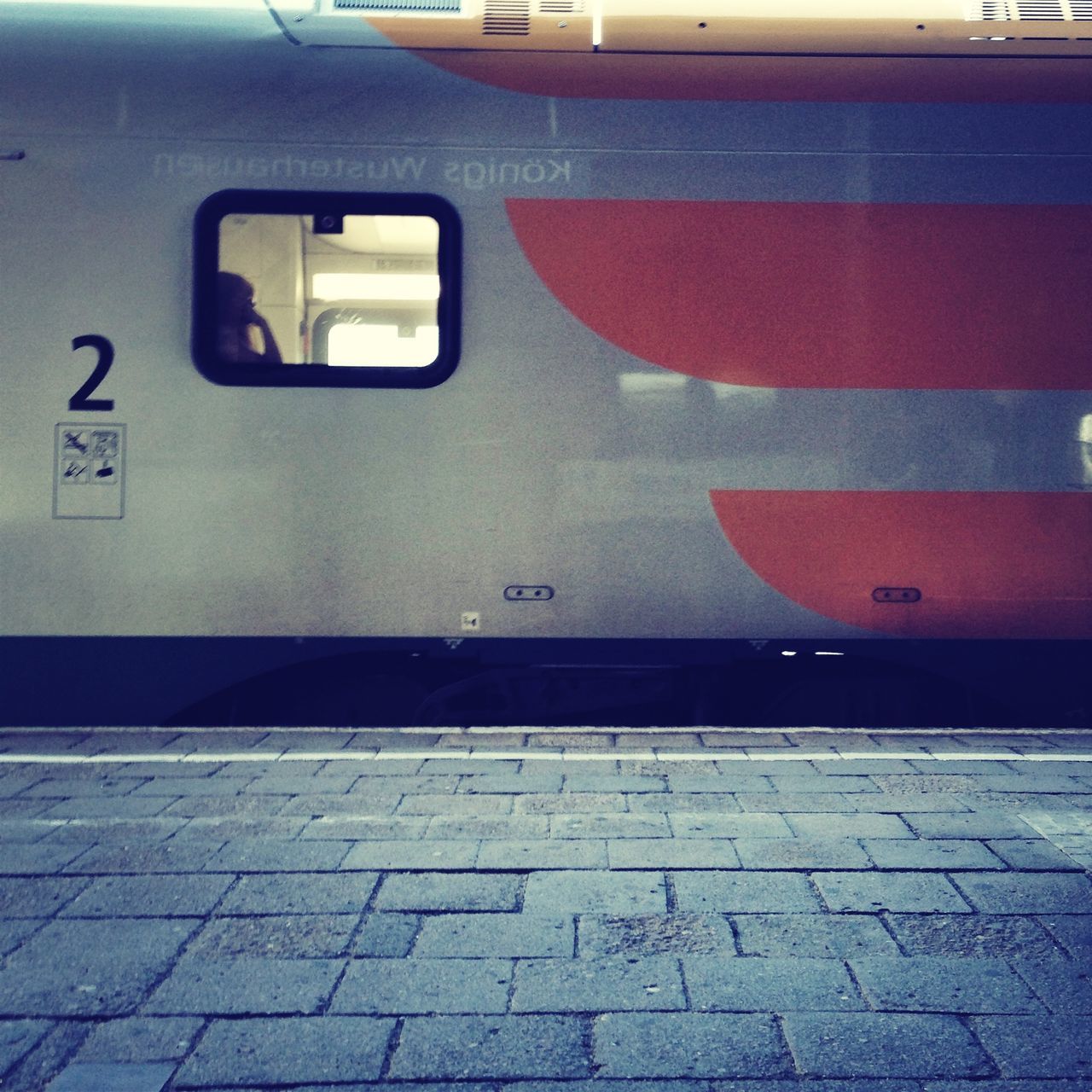 transportation, mode of transport, architecture, built structure, railroad station, road marking, street, public transportation, building exterior, land vehicle, railroad station platform, car, empty, road, travel, the way forward, no people, day, wall - building feature, city