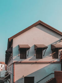 Low angle view of old historical building against clear blue sky