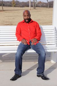 Portrait of a smiling young man sitting outdoors