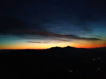 Scenic view of silhouette mountain against sky at sunset