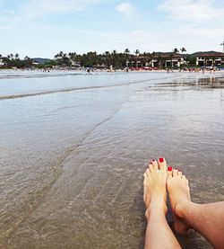 Low section of woman relaxing on beach