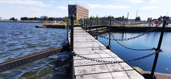 Pier over river against sky