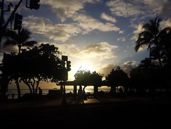 Silhouette palm trees against sky during sunset