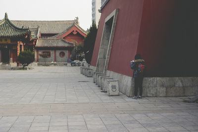 Man walking on cobblestone street