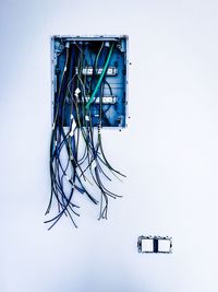 Low angle view of telephone pole against white background