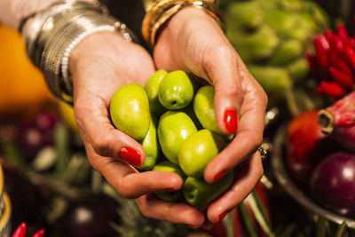 Midsection of woman holding fruits