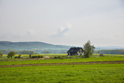 Barn on field against sky