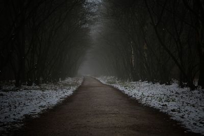 Empty road along snow covered land