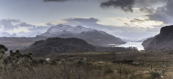 Scenic view of mountains against cloudy sky