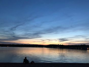 Scenic view of lake against sky during sunset