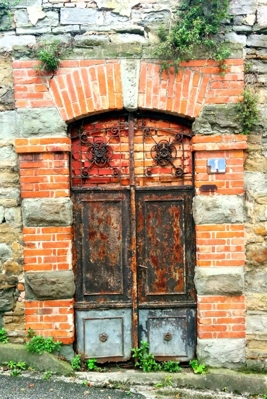 built structure, architecture, building exterior, door, old, wood - material, weathered, closed, abandoned, house, obsolete, wall - building feature, damaged, entrance, deterioration, wooden, run-down, brick wall, outdoors, day