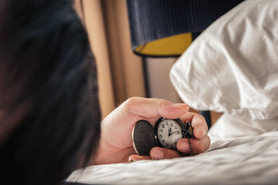 Close-up of hands working on bed