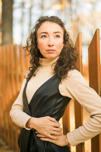 Portrait of young woman standing outdoors