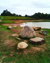 Scenic view of grassy field against cloudy sky