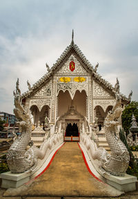 View of temple building against cloudy sky