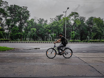 Man riding bicycle on road