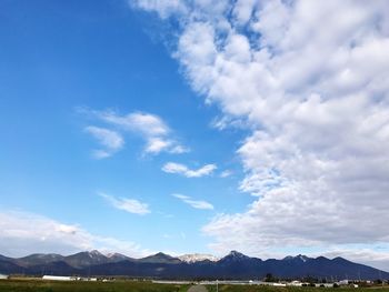 Scenic view of mountains against blue sky