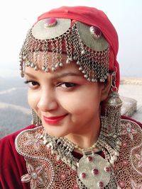 Close-up portrait of smiling woman wearing traditional clothing