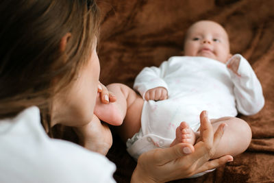 Organic cotton newborn baby clothes. cute newborn baby in white bodysuit made of organic cotton