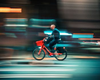 Side view of man riding bicycle