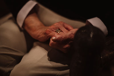 Midsection of senior woman holding hands